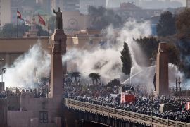 Riot police force protestors back across the Kasr Al Nile Bridge as they attempt to get into Tahrir Square on January 28, 2011 in downtown Cairo, Egypt. Thousands of police are on the streets of the capital and hundreds of arrests have been made in an attempt to quell anti-government demonstrations [Peter Macdiarmid/Getty Images]