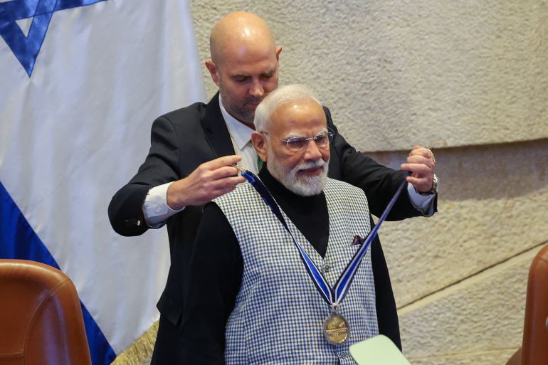 A man places a medal around another man