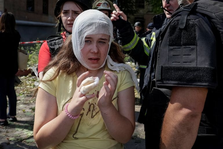 SENSITIVE MATERIAL. THIS IMAGE MAY OFFEND OR DISTURB A medical worker assists a wounded resident at a site of an apartment building hit by a Russian missile strike, amid Russia's attack on Ukraine, in Kharkiv, Ukraine July 8, 2026. REUTERS/Sofiia Gatilova TPX IMAGES OF THE DAY