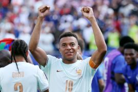 Mbappe raises his arms in celebration