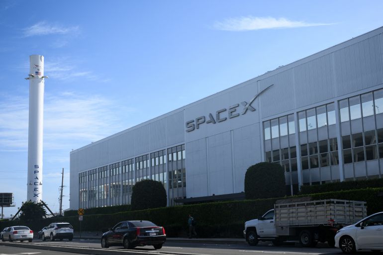 Vehicles drive past a SpaceX Falcon 9 rocket displayed outside a Space Exploration Technologies Corp. facility in Hawthorne, California, on June 8, 2026.