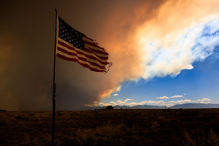 PUEBLO, COLORADO - JULY 1: Smoke from the Aspen Acres fire rises above a home on July 1, 2026 in Pueblo, Colorado. Over 35,000 acres and more than 100 structures have burned in the Aspen Acres fire, one of several blazes that are currently burning across the state after a warm and dry winter. Michael Ciaglo/Getty Images/AFP (Photo by Michael Ciaglo / GETTY IMAGES NORTH AMERICA / Getty Images via AFP)