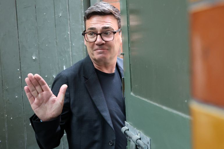 Labour MP and challenger for Leader of the Labour party, Andy Burnham, waves as he leaves after delivering a speech in Manchester, northern England, on June 29, 2026.