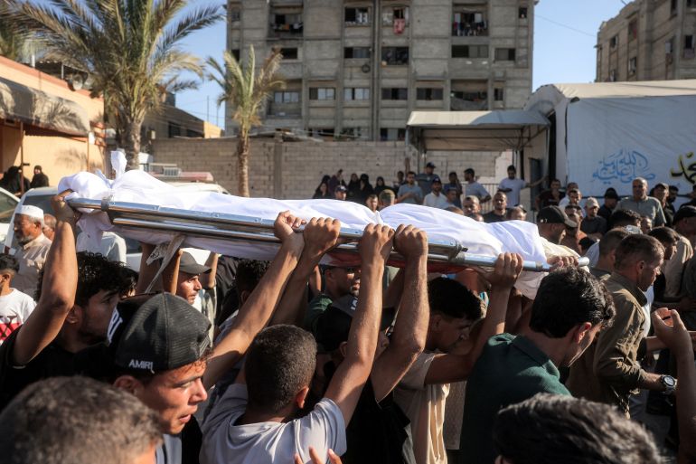EDITORS NOTE: Graphic content / Mourners carry the body of a victim who was killed in a reported Israeli strike on a tent according to medics, outside Nasser Medical Complex in Khan Yunis in the southern Gaza Strip on July 8, 2026.
