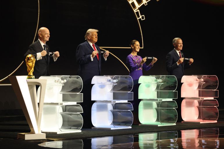FIFA President Gianni Infantino, US President Donald Trump, Mexico's President Claudia Sheinbaum and Canada's Prime Minister Mark Carney pose with their cards during the draw for the 2026 FIFA Football World Cup.