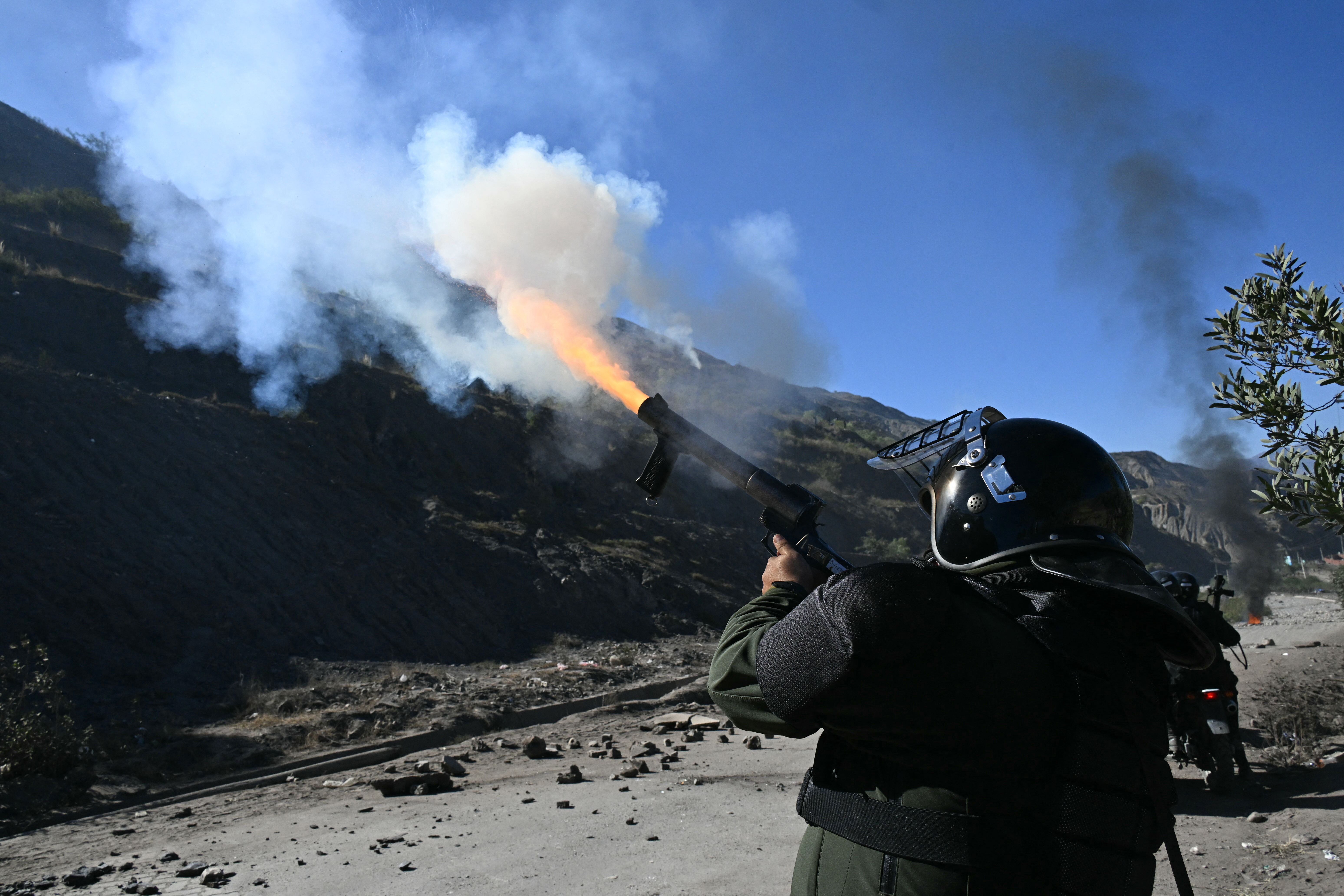 Riot police officers stand guard during clashes with rural protesters in Lipari, La Paz