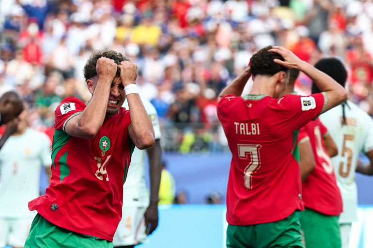 Morocco's midfielder #24 Neil El Aynaoui reacts to a missed chance along with other Morocco players.