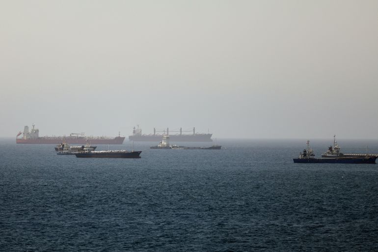 Tankers and cargo vessels are seen at sea.