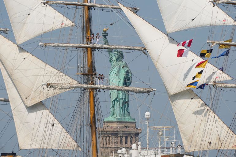 The Statue of Liberty is framed by Argentina's Ara Libertad in the New York harbor during the International Parade of Sail, part of Sail250, a gathering of tall ships and military ships, Saturday, July 4, 2026, in New York. (AP Photo/Yuki Iwamura)