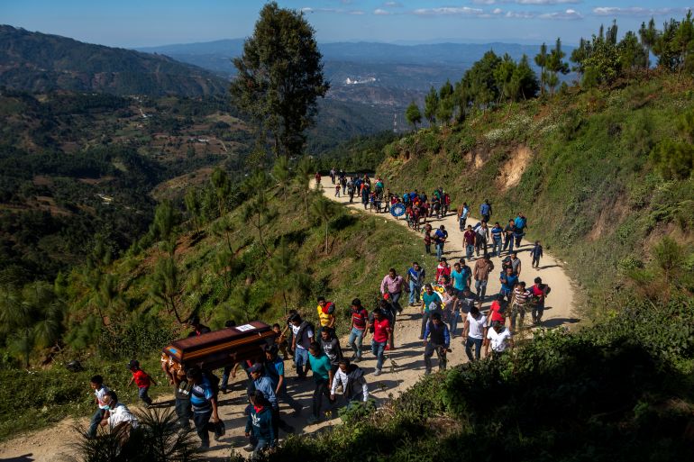 Relatives carry the coffin containing the remains of Guatemalan migrant Aurelio Cuy Tamat, 27, in Santa Apolonia, Guatemala, Friday, Dec. 31, 2021. Cuy Tamat was one of 56 people who was killed when a truck carrying Central American migrants rolled over on a highway in Tuxtla, Mexico, on Dec. 9. (AP Photo/Oliver de Ros)