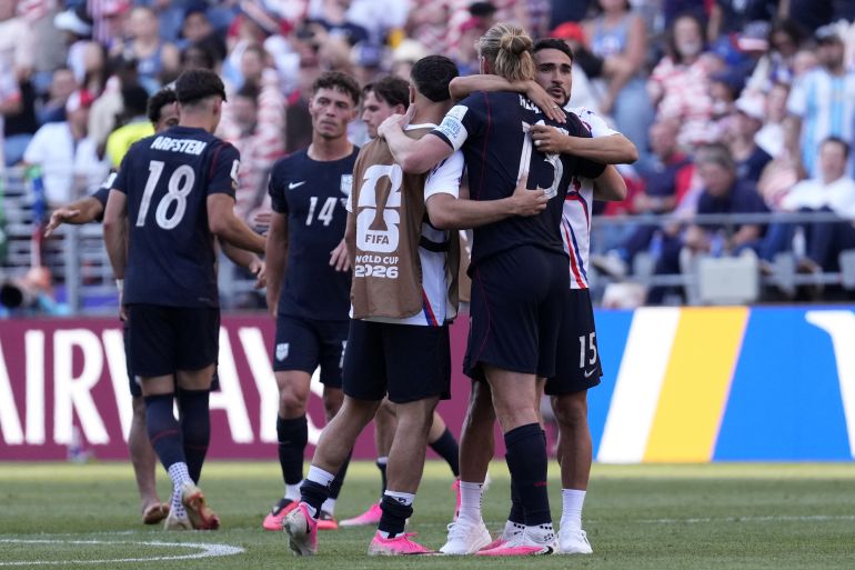 epa13093499 Players of USA comfort each other after losing the FIFA World Cup 2026 Round of 16 match USA against Belgium, in Seattle, Washington, USA, 06 July 2026. EPA/STEPHEN BRASHEAR