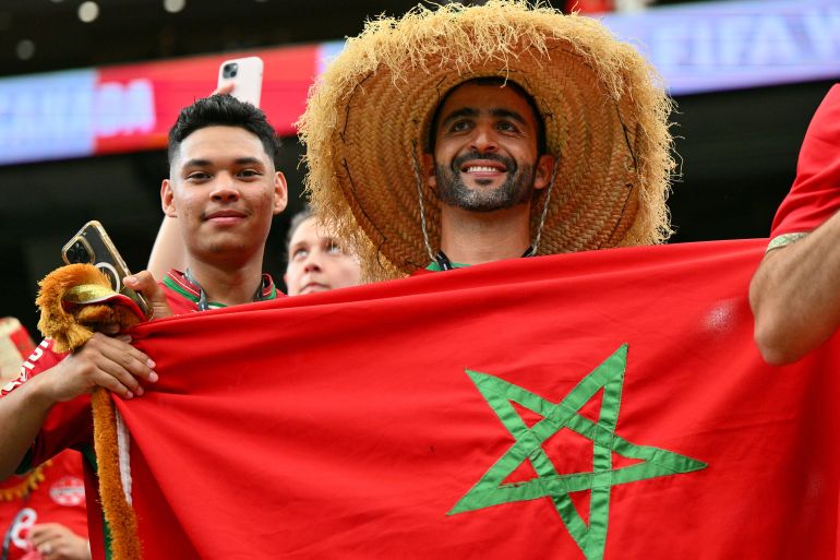 Moroccan football fans hold up the country's flag