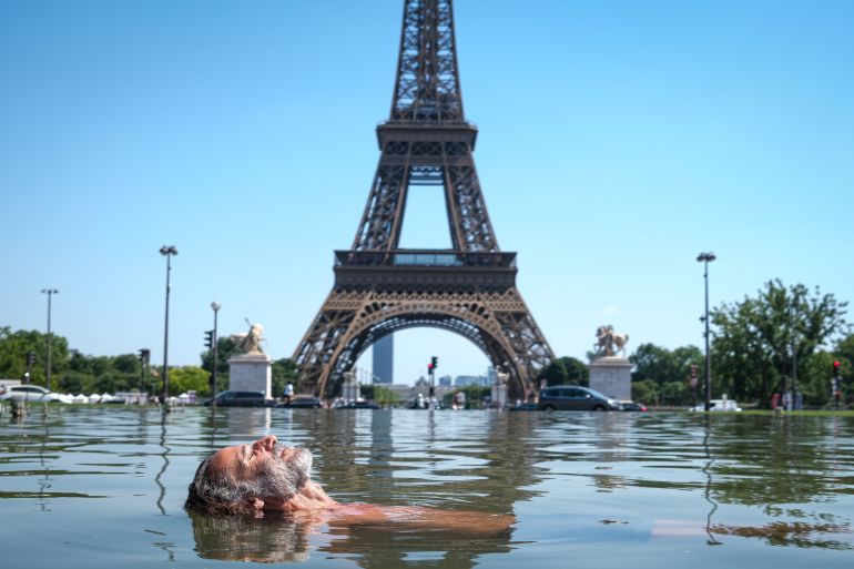 PARIS, FRANCE - JUNE 24: A man cools off in the Warsaw Fountain at the Jardins du Trocadéro in front of the Eiffel Tower during hot weather on June 24, 2026 in Paris, France. Various European governments issued health warnings this week in relation to the high temperatures, which were nearing 40 degrees celsius in many large cities. (Photo by Annice Lyn/Getty Images)