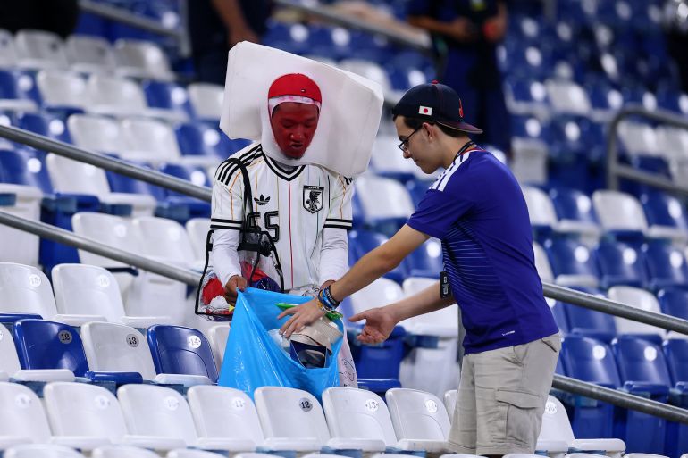 Soccer Football - FIFA World Cup 2026 - Group F - Tunisia v Japan - Estadio Monterrey, Monterrey, Mexico - June 21, 2026 Japan fans clean up rubbish in the stands after the match REUTERS/Eloisa Sanchez