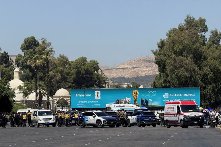 Emergency vehicles and personnel are seen.