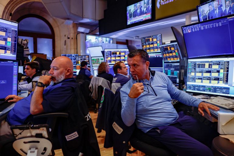Traders work on the floor of the New York Stock Exchange (NYSE) in New York City, U.S., July 6, 2026. REUTERS/Jeenah Moon