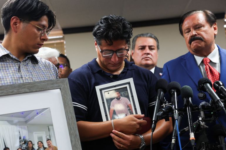 A family member holds a picture of a Mexican motorist identified as Lorenzo Salgado Araujo who was fatally shot by an ICE agent, during a news conference, in Houston, Texas, U.S., July 8, 2026. REUTERS/Antranik Tavitian