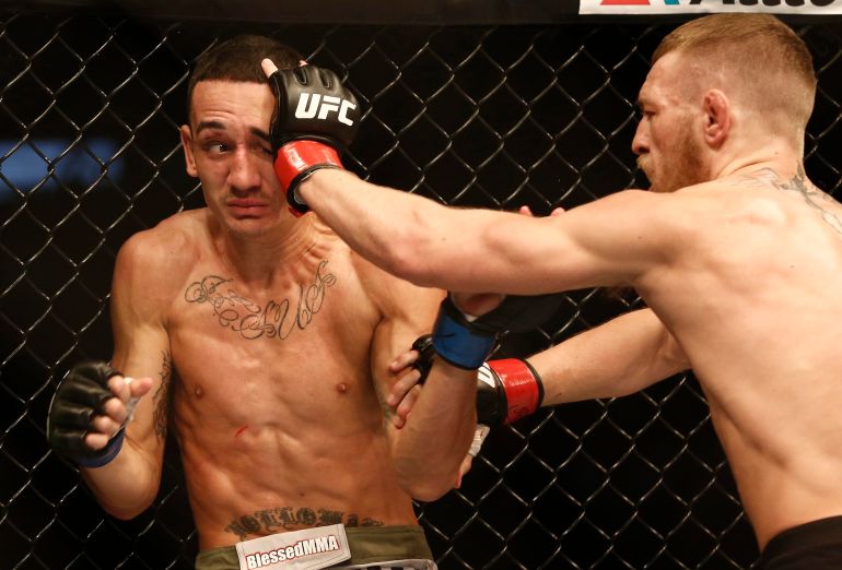 Aug 17, 2013; Boston, MA, USA; Conor McGregor (black shorts) and Max Holloway (white shorts) fight during a UFC featherweight match at the TD Garden. McGregor won after three rounds by judges decision. Mandatory Credit: Winslow Townson-USA TODAY Sports