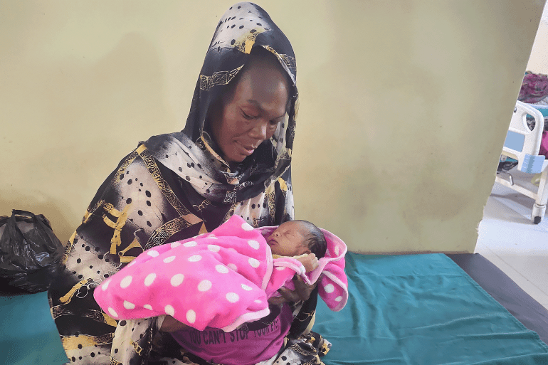 Touma Jabara gave birth to her baby daughter, Duaa, at the Maternity Hospital in Omdurman [Mohammed Mirghani/Al Jazeera]